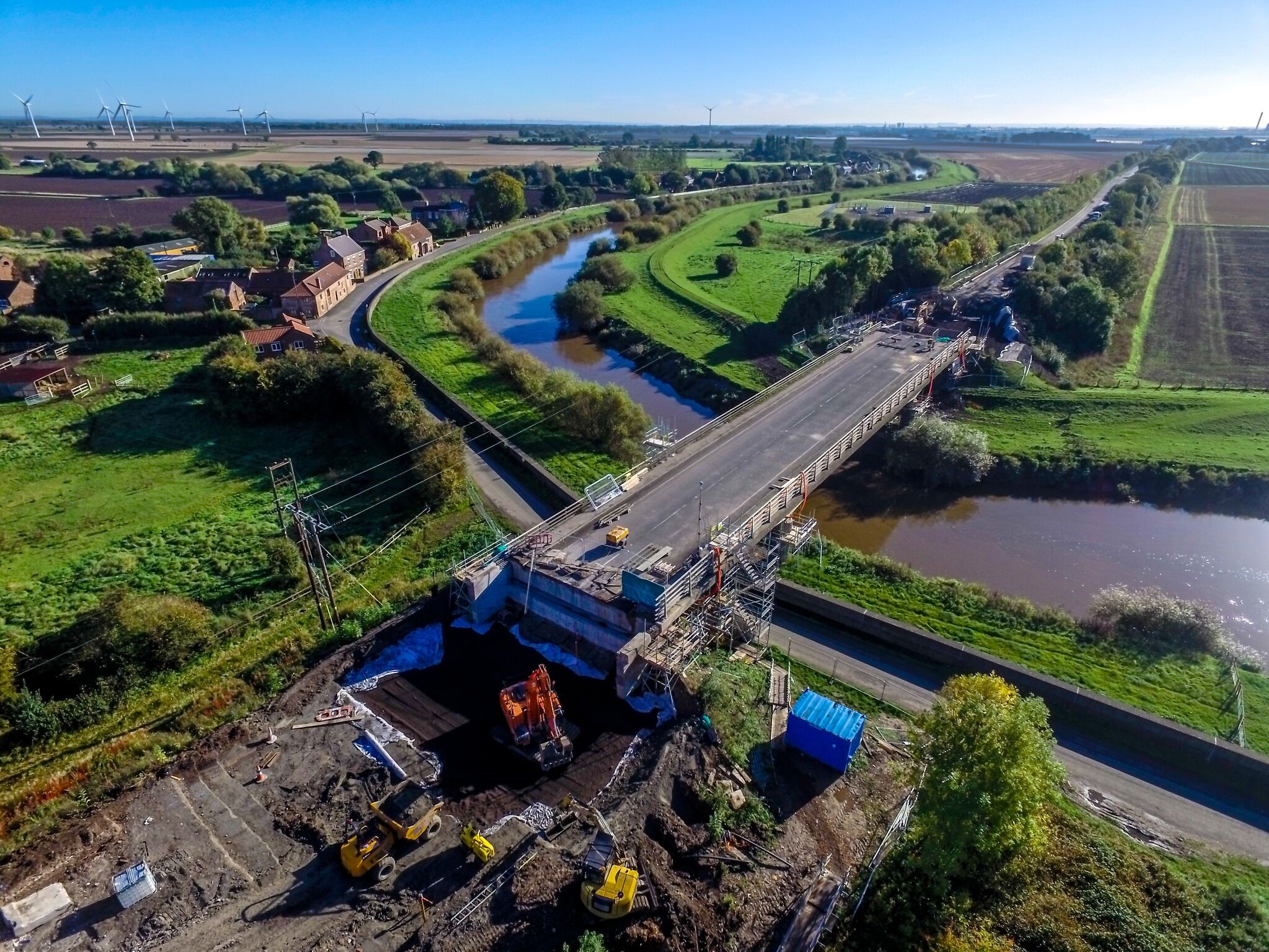 Aerial view of a bridge construction site spanning over a river