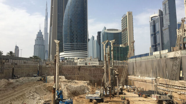 A construction site scene with workers and machinery